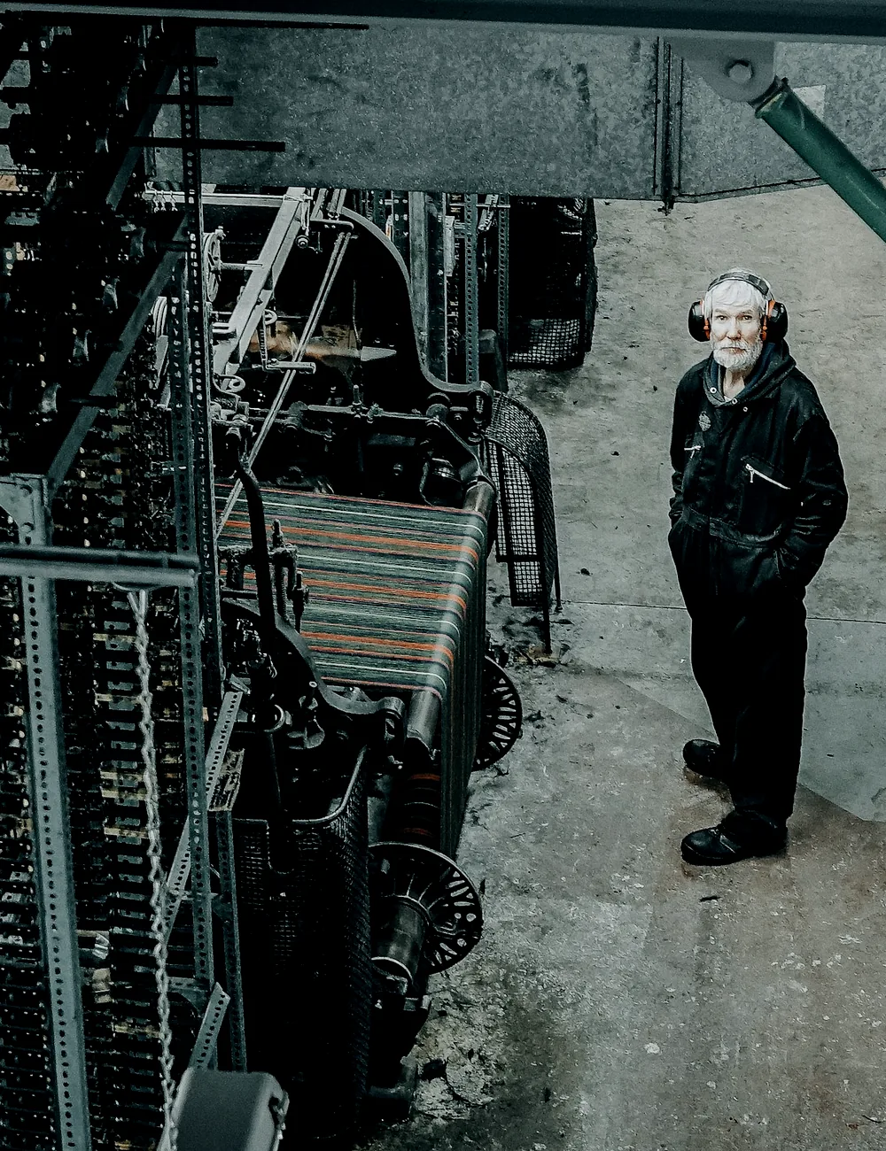 Engineer standing beside large industrial machinery