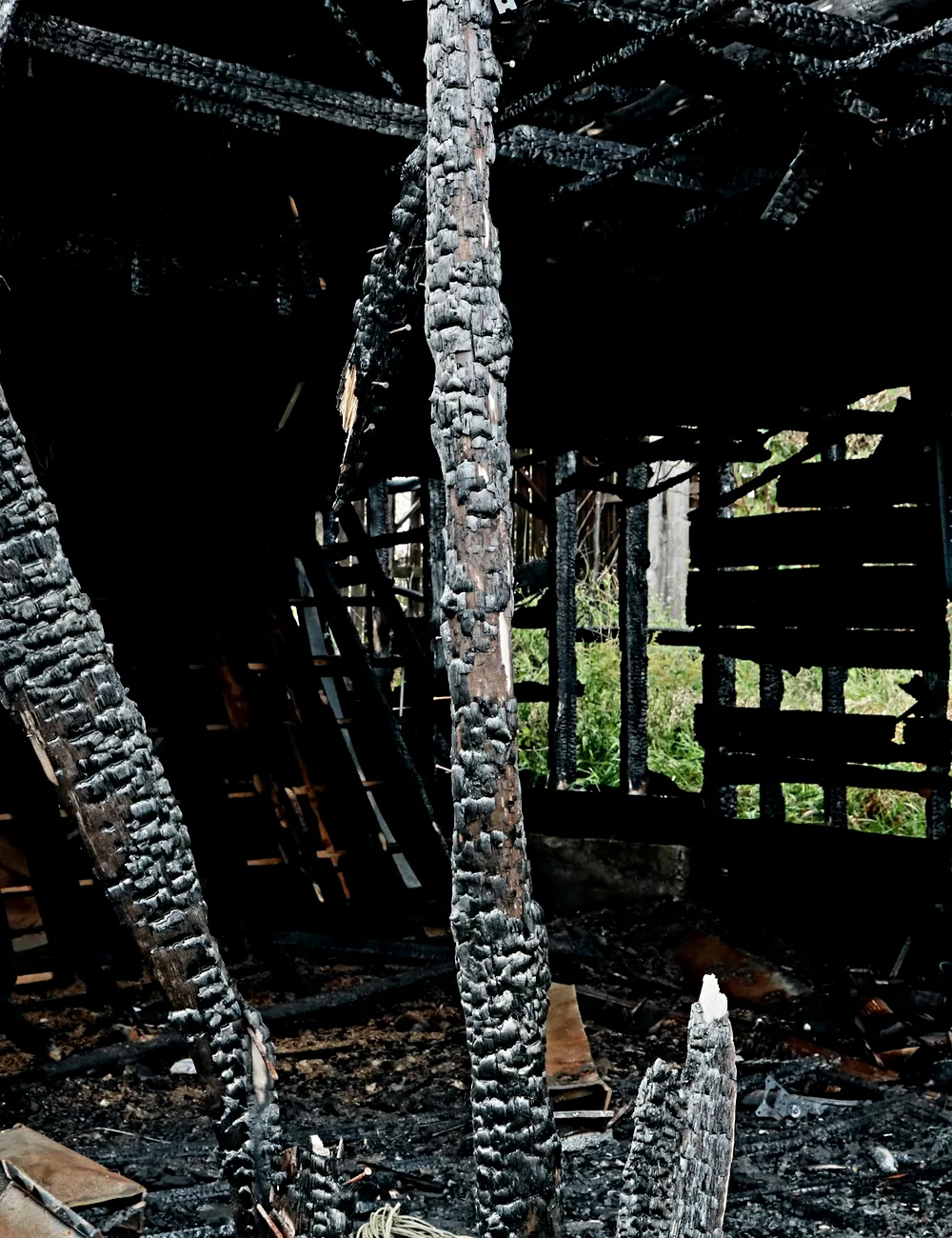 Charred structural timbers inside a fire-damaged building